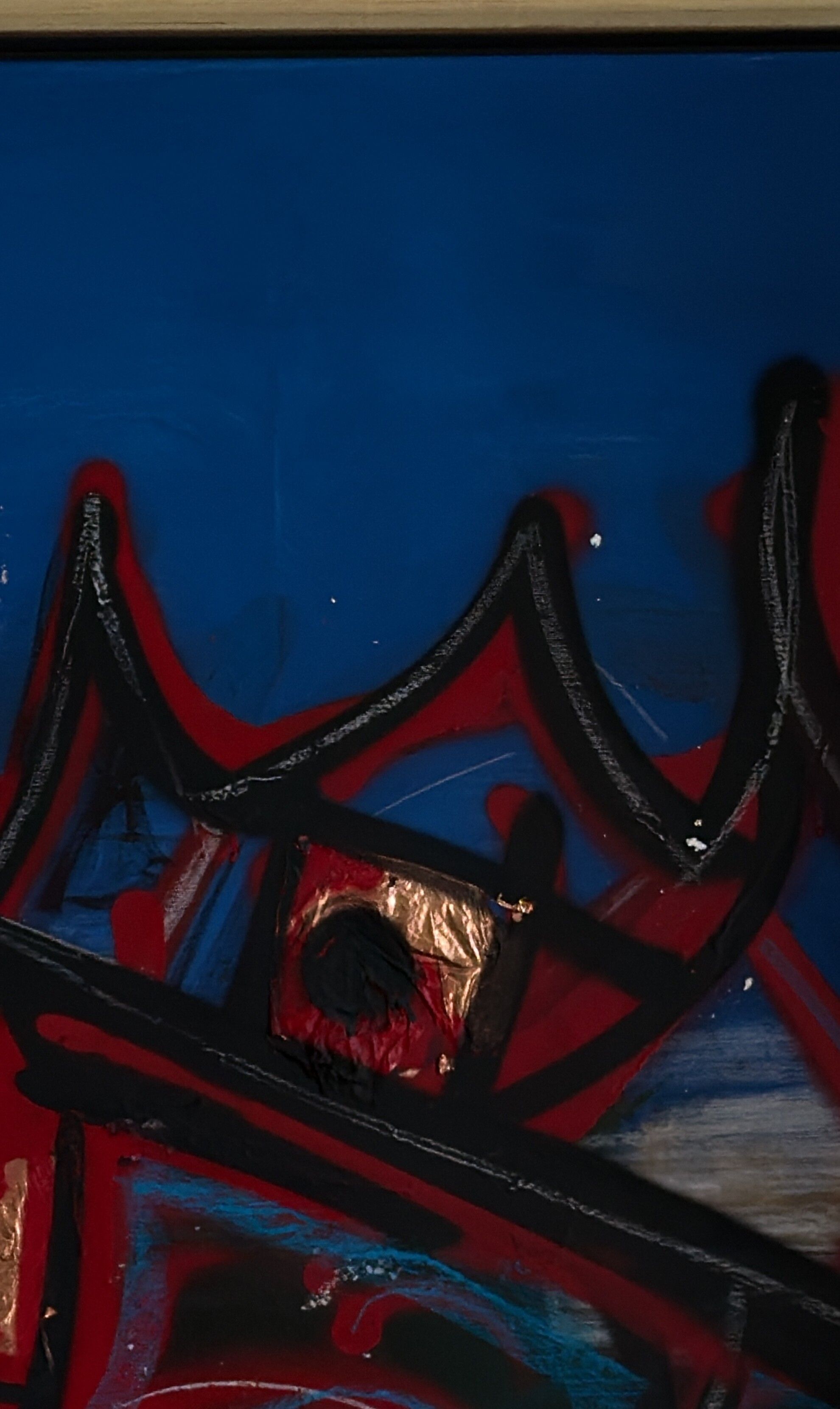 Close-up of the crown and a square of gold leaf in Coronation of noise